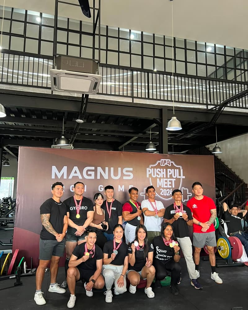 Jasson Thio with his medal among the competitors at the Magnus Iron Game Push and Pull Meet 2024
