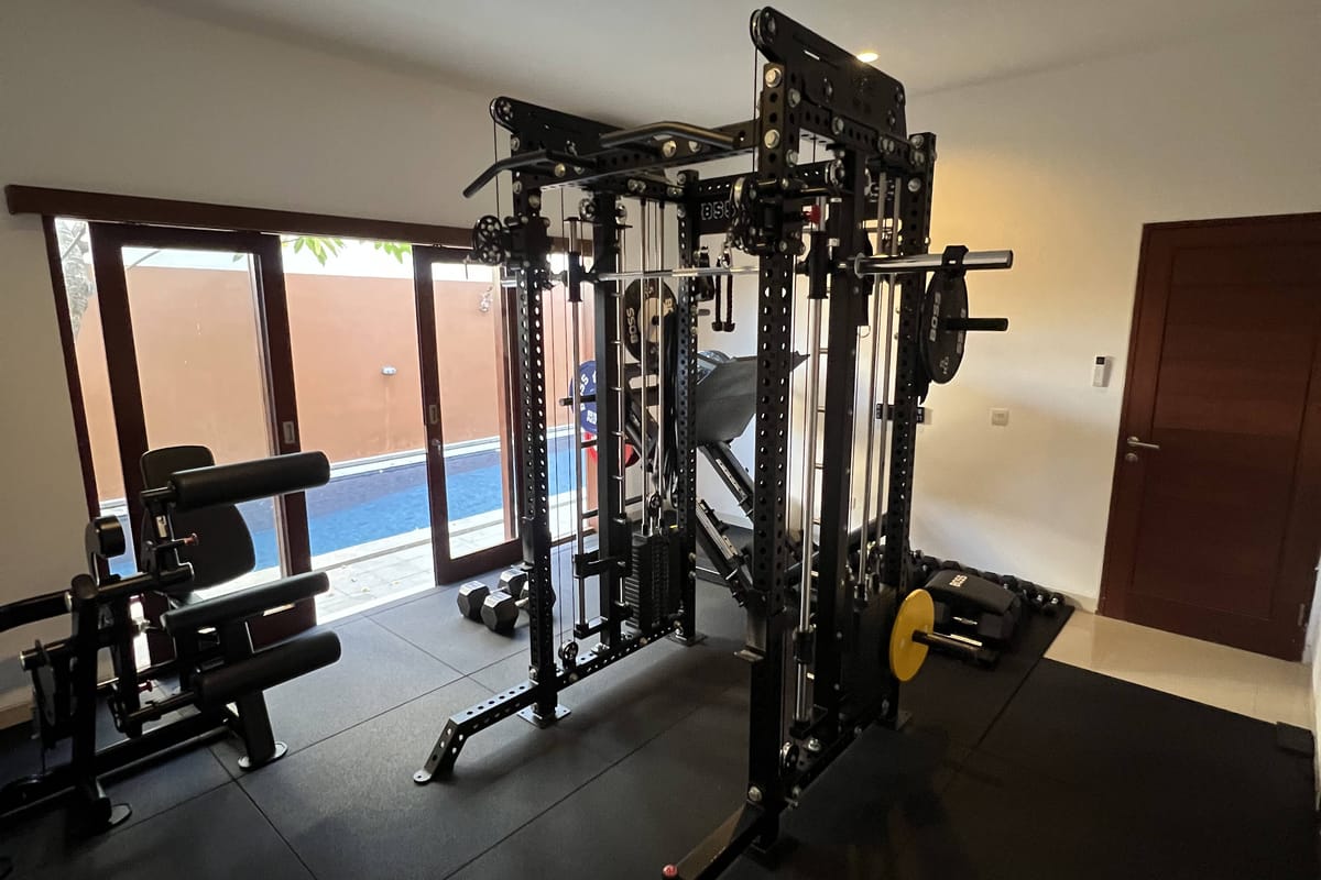 Jasson Thio's private home gym in Sanur with a power rack, cable machine and free weights